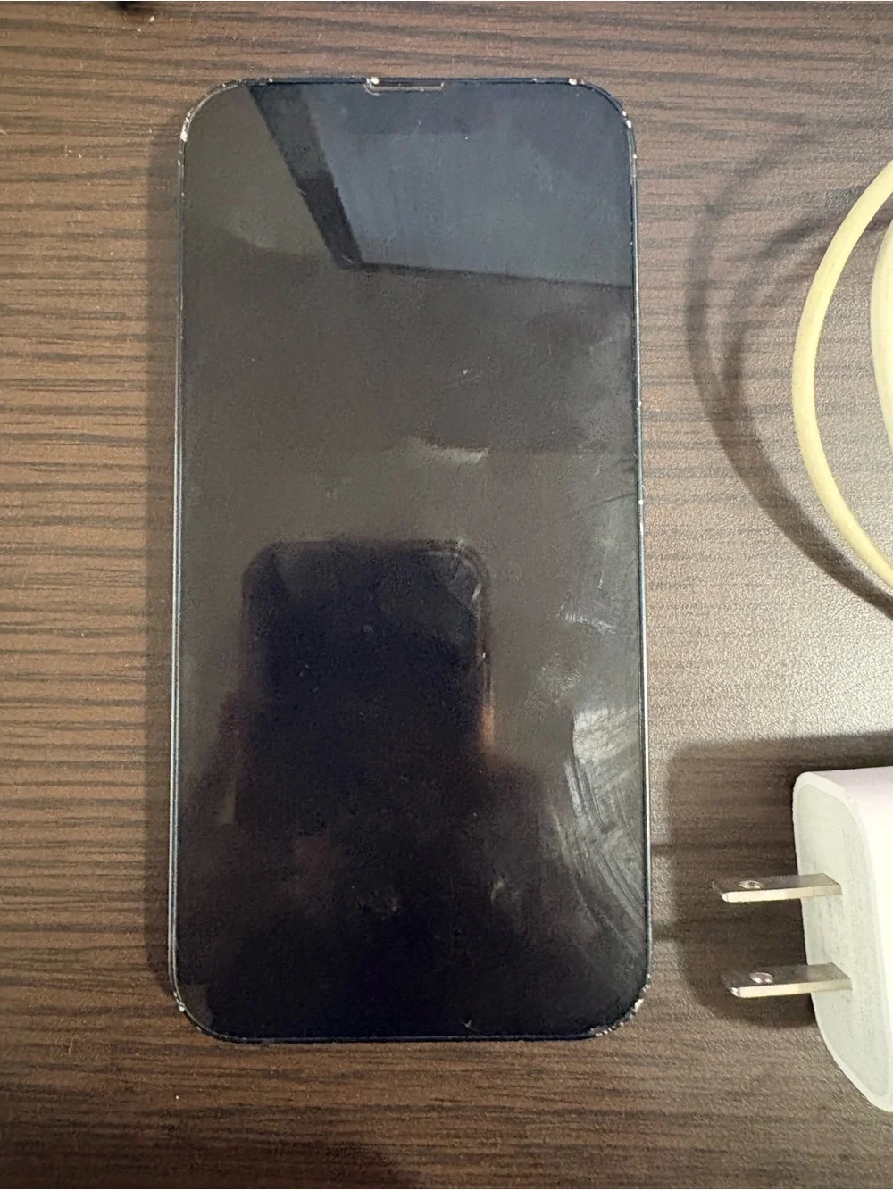 White Smartphone with White Charging Cable and Wall Adapter